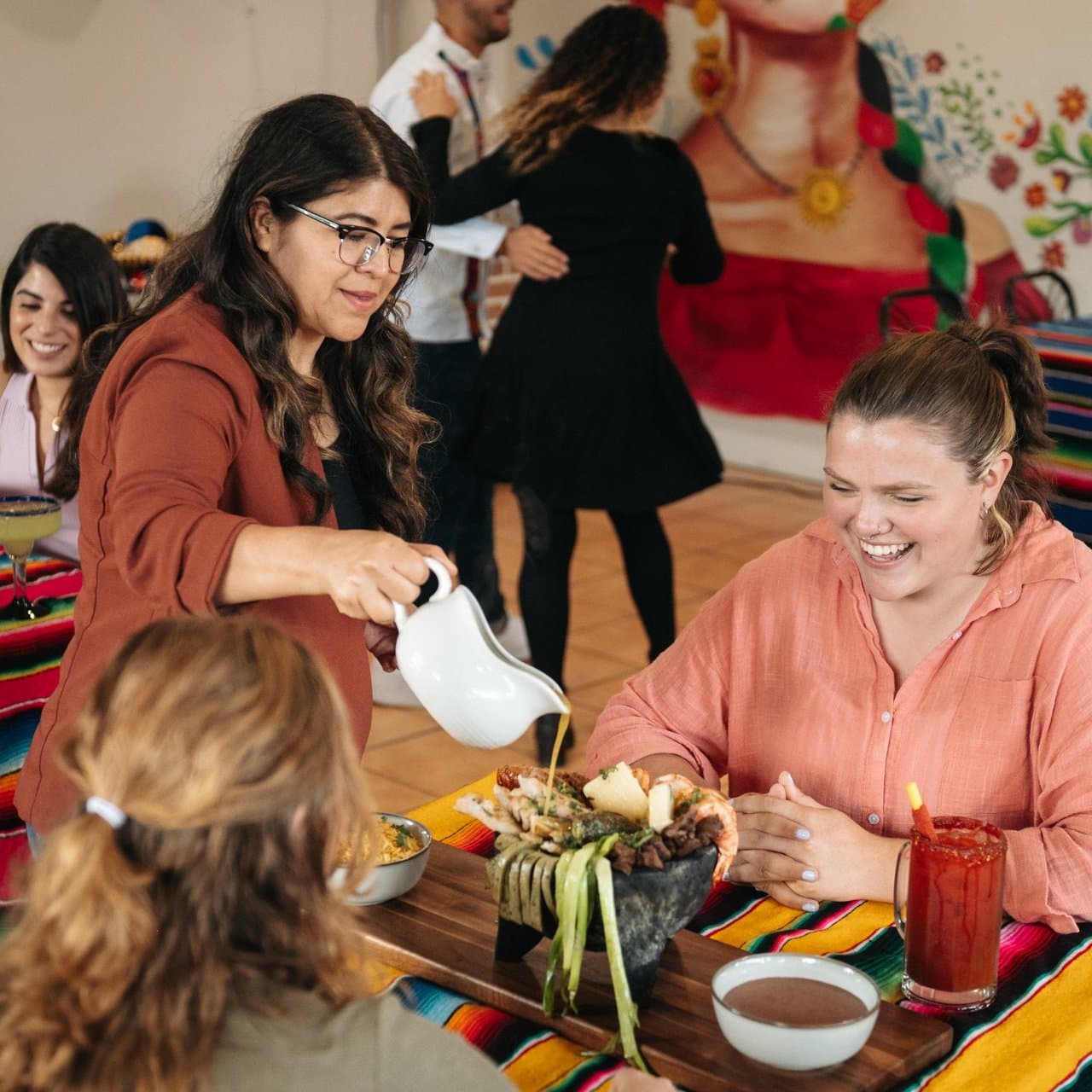 Diners-at-guacamole-mexican-grill-in-surrey-being-served-a-signature-dish-with-dancers-in-the-background-Ian-Harland-DSC_1607__FocusFillMaxWyItMC4wMSIsIjAuMzkiLDE5MjAsMTkyMF0.jpg
